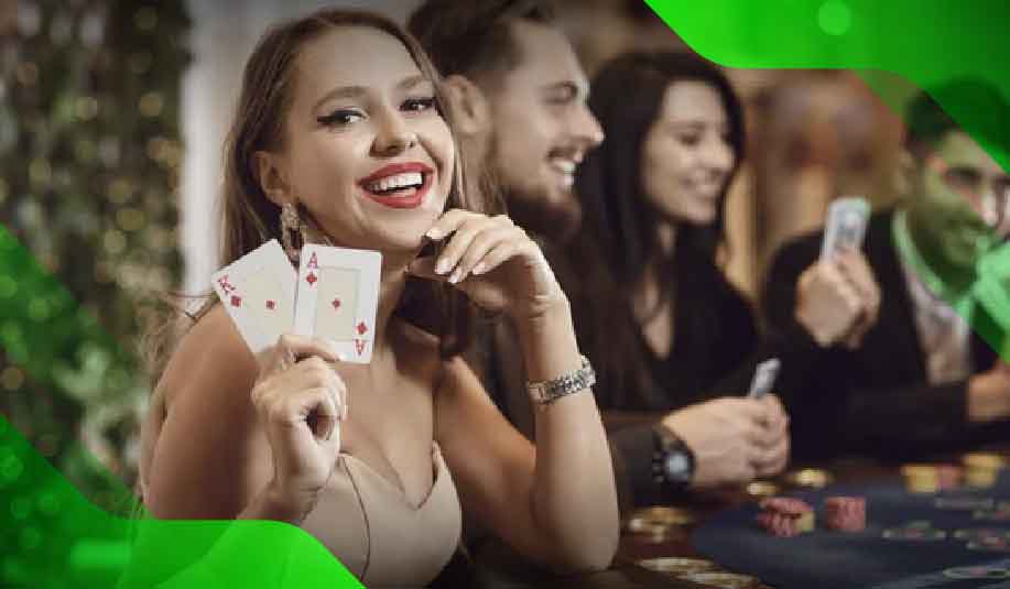 Smiling casino player holding cards at a blackjack table, suggesting the potential for strategic advantage in choosing the right game.